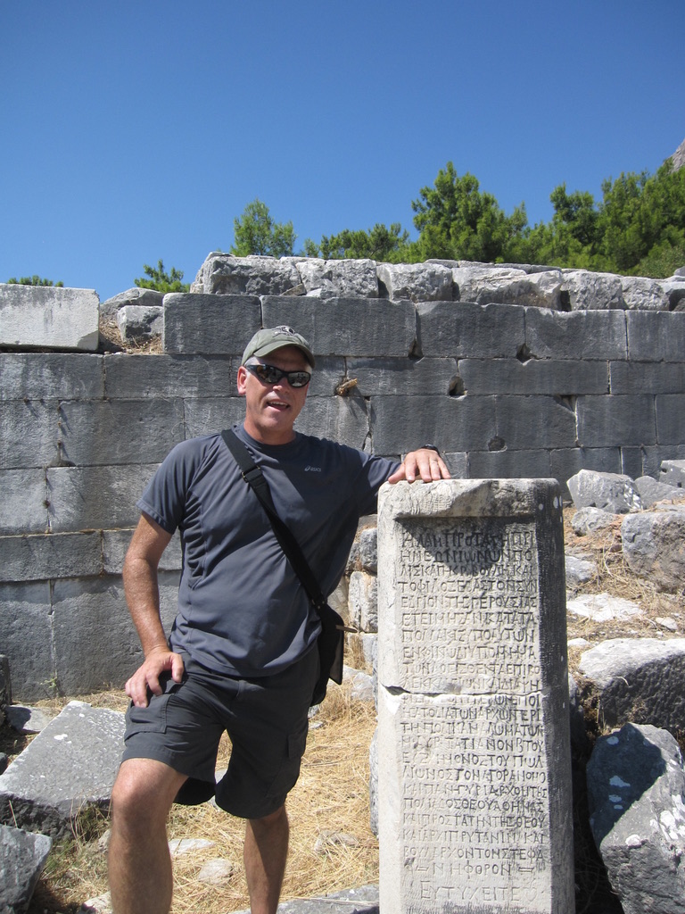 Brendan C. Curran, host of the Trails and TNT podcast, stands by ancient ruins